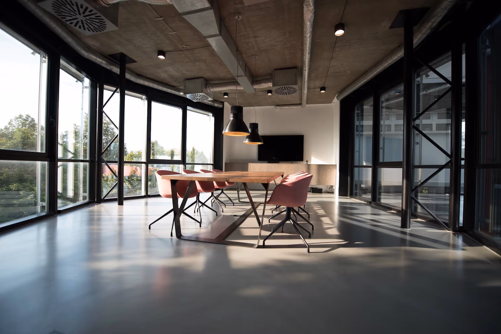 A sunlit meeting room, chairs drawn to the table