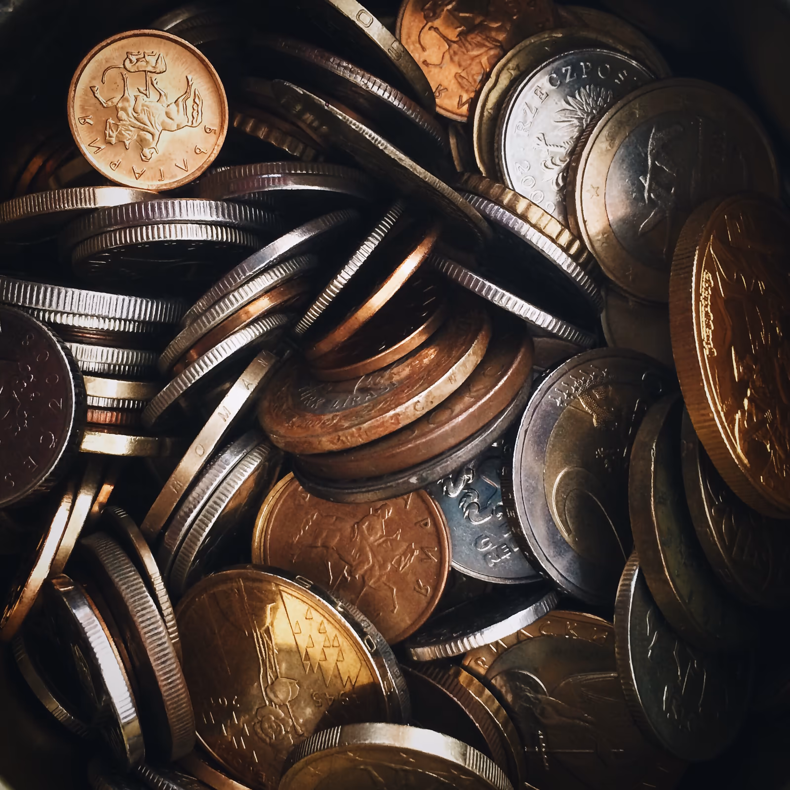A close-up of overlapping copper and silver coins